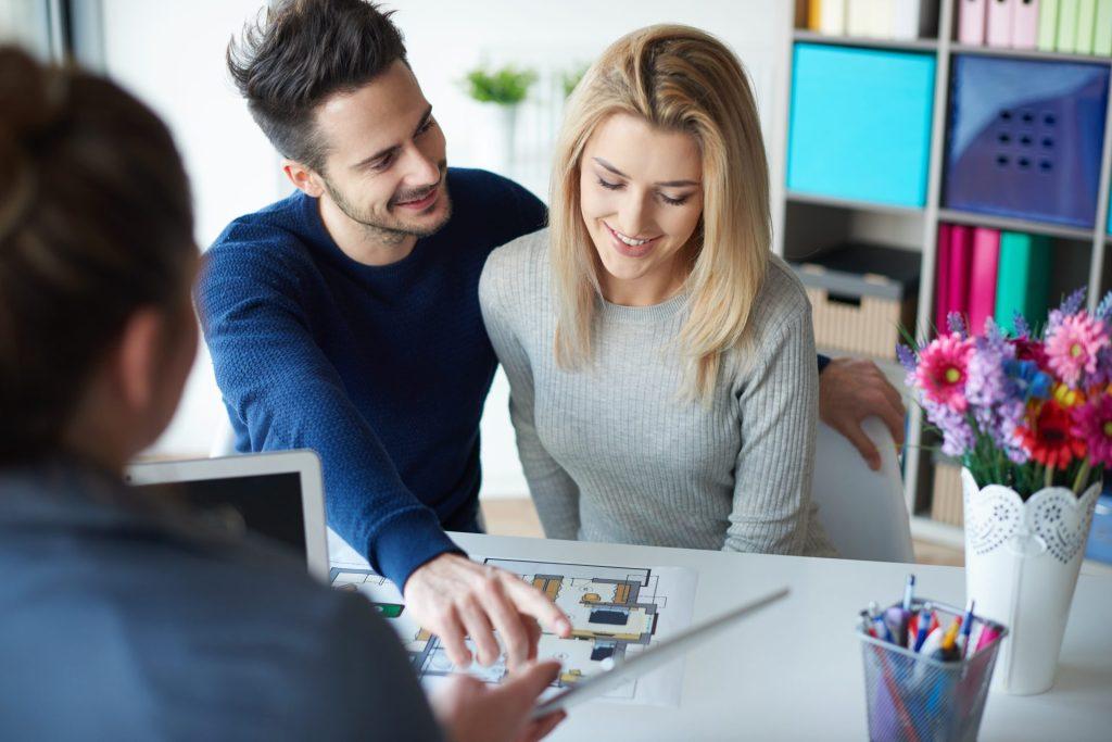 Couple meeting with a mortgage professional to review home buying and pre-approval documents in Missouri