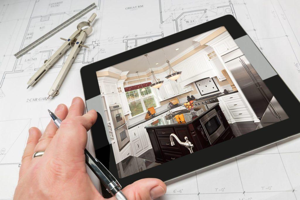 Tablet displaying modern kitchen remodel design over architectural blueprints for home renovation financing blog